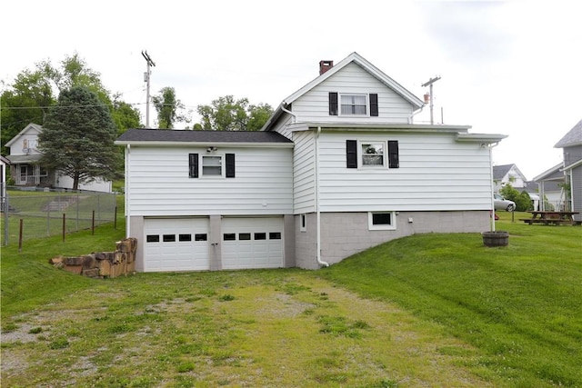 23 Main St, W Pike Run Twp, PA 15427 - rear view of property with an attached garage, a chimney, and driveway