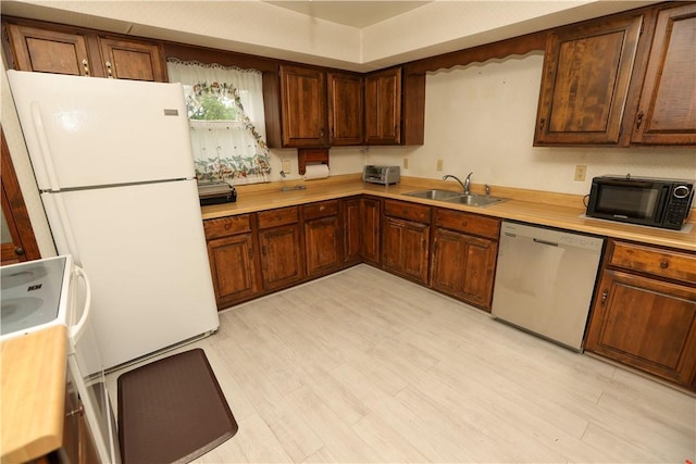 23 Main St, W Pike Run Twp, PA 15427 - kitchen featuring white appliances, a sink, light countertops, and light wood finished floors