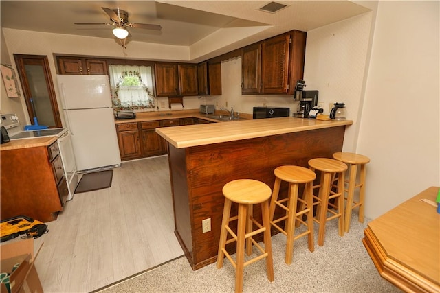 23 Main St, W Pike Run Twp, PA 15427 - kitchen with white appliances, a sink, a peninsula, and light countertops