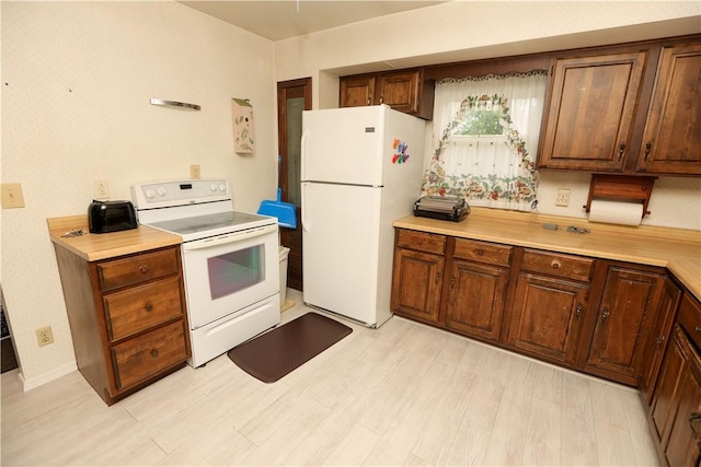 23 Main St, W Pike Run Twp, PA 15427 - kitchen featuring white appliances, light wood finished floors, and light countertops