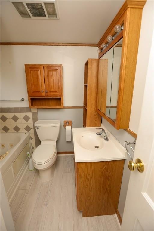 23 Main St, W Pike Run Twp, PA 15427 - bathroom with a whirlpool tub, vanity, toilet, and wood finished floors