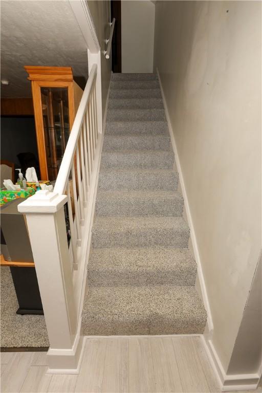 23 Main St, W Pike Run Twp, PA 15427 - stairs with baseboards and wood finished floors