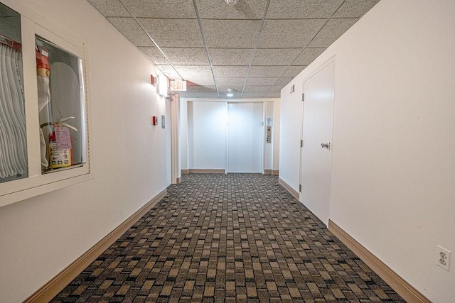 333 S Highland Ave Unit 303, Shadyside, PA 15206 - hallway featuring baseboards, a paneled ceiling, and brick patterned floors