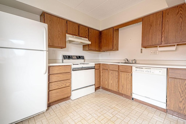 333 S Highland Ave Unit 303, Shadyside, PA 15206 - kitchen featuring white appliances, under cabinet range hood, a sink, light countertops, and brick patterned flooring