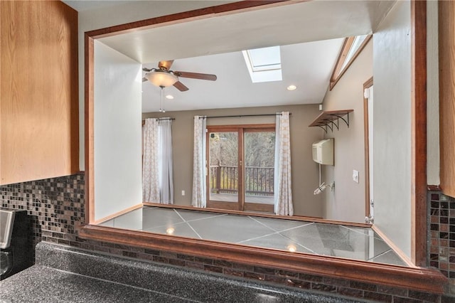 459 E Garden Rd, Brentwood, PA 15227 - bathroom featuring a skylight, tasteful backsplash, and a ceiling fan