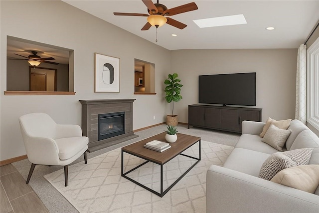 459 E Garden Rd, Brentwood, PA 15227 - living area featuring a ceiling fan, a glass covered fireplace, baseboards, a skylight, and recessed lighting