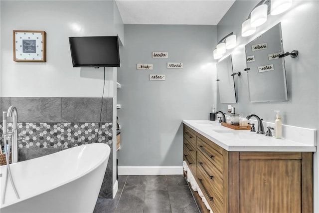 127 Aberdeen Dr, Cranberry Twp, PA 16066 - bathroom with a freestanding bath, double vanity, and baseboards