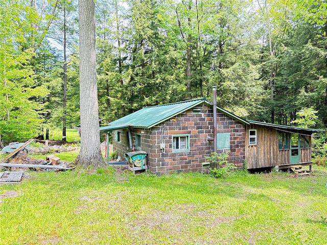 23682 Rte 949, Ridgway, PA 15853 - view of property exterior with metal roof, a yard, and a view of trees