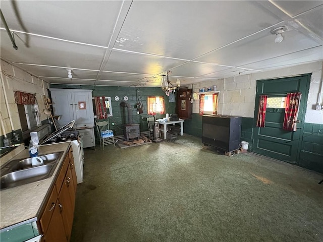 23682 Rte 949, Ridgway, PA 15853 - garage with a wood stove, concrete block wall, and a sink