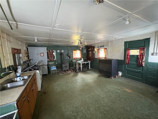 23682 Rte 949, Ridgway, PA 15853 - kitchen featuring a wood stove, a sink, concrete block wall, and washer / dryer