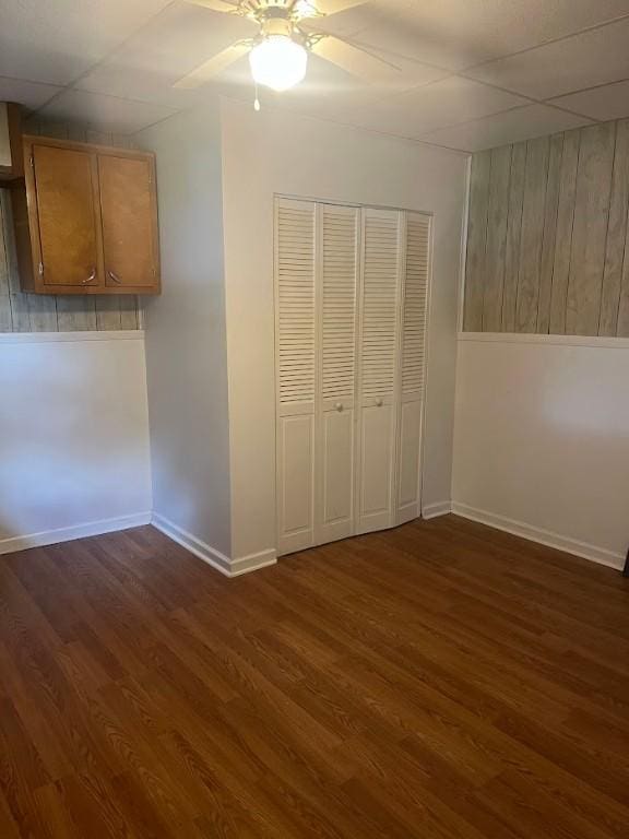 116 Third St, West Bethlehem, PA 15368 - unfurnished bedroom with wood finished floors, baseboards, a paneled ceiling, wood walls, and a closet