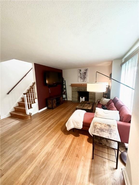 1425 Elgin, Aliquippa, PA 15001 - living area with a textured ceiling, wood finished floors, stairs, and a fireplace
