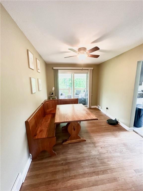 1425 Elgin, Aliquippa, PA 15001 - dining area with wood finished floors, a ceiling fan, baseboards, breakfast area, and baseboard heating