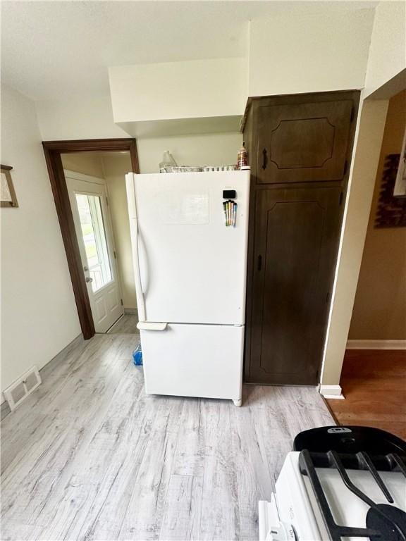 1425 Elgin, Aliquippa, PA 15001 - kitchen with freestanding refrigerator, light wood-style flooring, baseboards, and dark brown cabinets