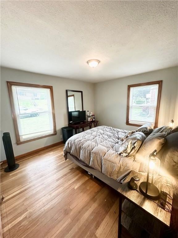 1425 Elgin, Aliquippa, PA 15001 - bedroom with light wood-type flooring, multiple windows, a textured ceiling, and baseboards