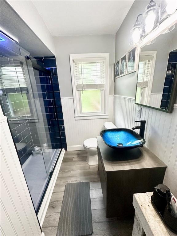 1425 Elgin, Aliquippa, PA 15001 - full bathroom featuring a wainscoted wall, toilet, a stall shower, wood finished floors, and vanity