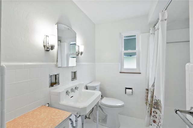 55 Lawrence St, Shaler, PA 15209 - bathroom featuring toilet, tile walls, a sink, and a wainscoted wall