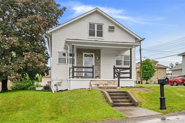 425 Routh Dr, Monroeville, PA 15146 - shotgun-style home with a porch, a front lawn, and central air condition unit