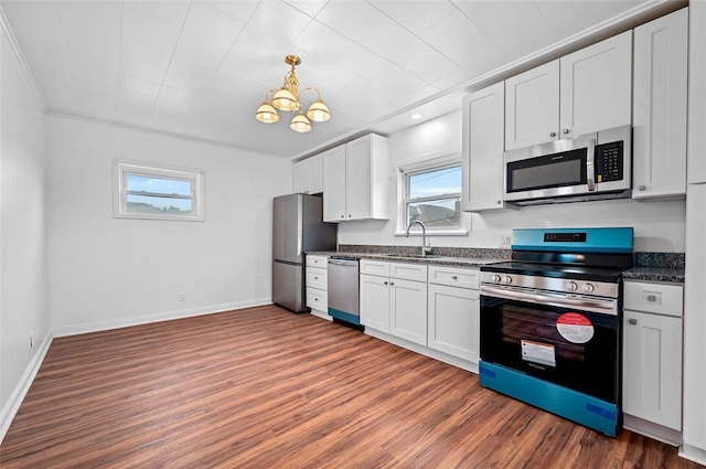 425 Routh Dr, Monroeville, PA 15146 - kitchen featuring appliances with stainless steel finishes, healthy amount of natural light, a sink, dark wood finished floors, and crown molding