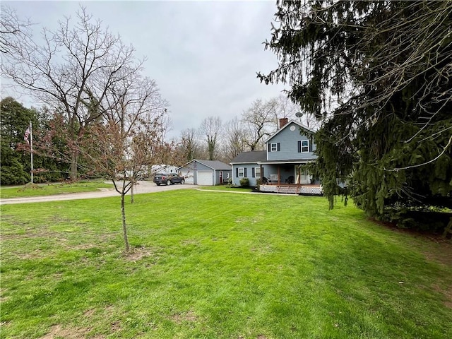 2513 Old Rte 18, New Beaver Boro, PA 16157 - view of front of house with a chimney, concrete driveway, a front yard, and covered porch