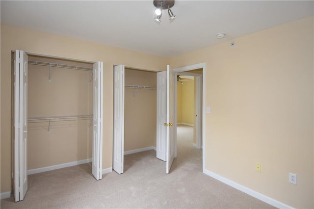 1201 Lenox Oval, Ross Twp, PA 15237 - unfurnished bedroom featuring multiple closets, light carpet, and baseboards