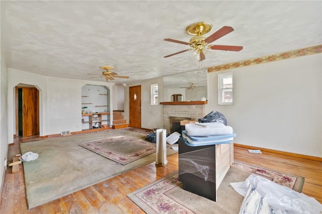 828 Georgia Ave, Bon Air, PA 15210 - living room featuring a ceiling fan, wood finished floors, a fireplace, and baseboards