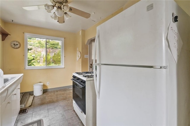 828 Georgia Ave, Bon Air, PA 15210 - kitchen featuring white appliances, ceiling fan, baseboards, and white cabinetry