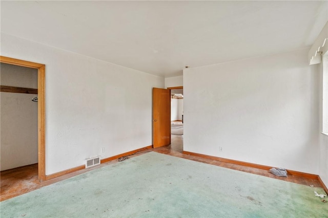 828 Georgia Ave, Bon Air, PA 15210 - unfurnished bedroom featuring baseboards, carpet flooring, a closet, and a walk in closet
