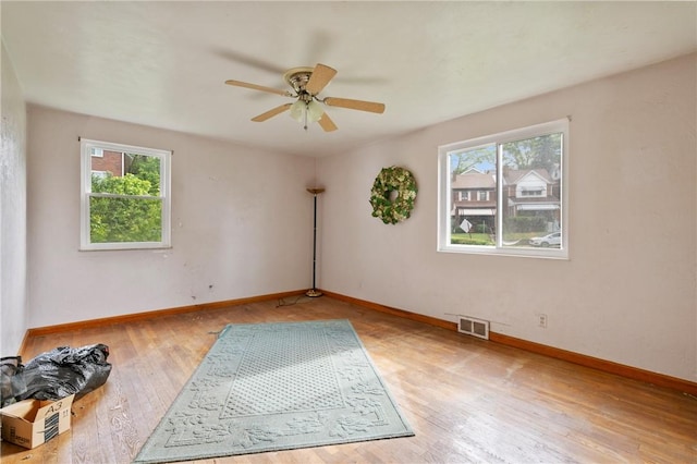 828 Georgia Ave, Bon Air, PA 15210 - empty room with healthy amount of natural light, ceiling fan, wood finished floors, and baseboards