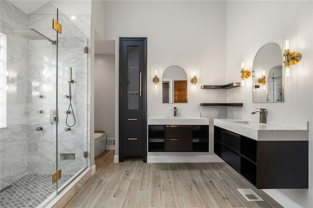 229 Guckert Ln, Marshall, PA 15090 - full bathroom featuring a stall shower, wood finish floors, two vanities, and toilet