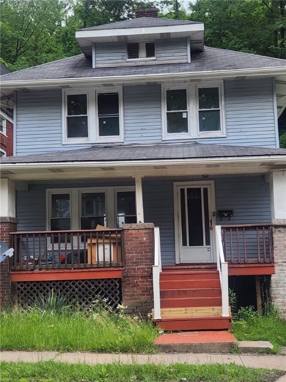 310 Brown Ave, Turtle Creek, PA 15145 - american foursquare style home featuring a porch and roof with shingles