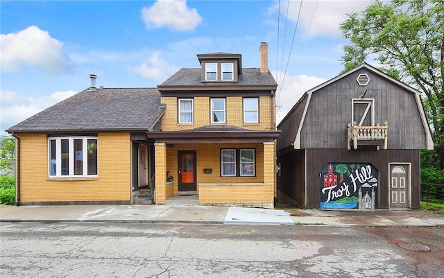 1521 Claim St, Troy Hill, PA 15212 - view of front of home with brick siding, a chimney, and roof with shingles