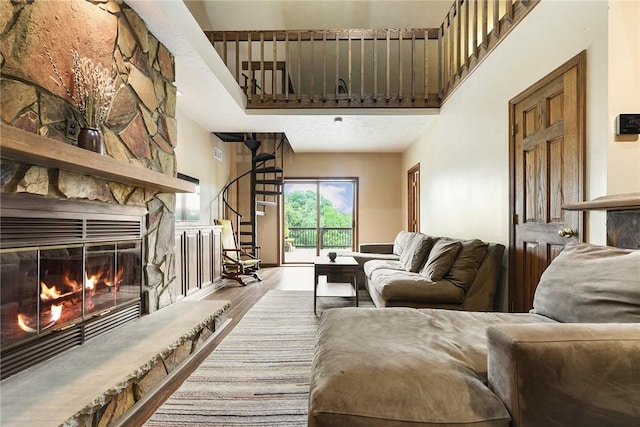 1521 Claim St, Troy Hill, PA 15212 - living area with stairway, a towering ceiling, wood finished floors, and a fireplace