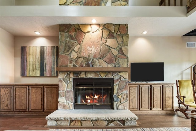 1521 Claim St, Troy Hill, PA 15212 - living room featuring wood finished floors and a stone fireplace