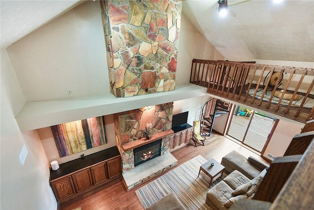 1521 Claim St, Troy Hill, PA 15212 - living room with wood finished floors, a fireplace, and lofted ceiling