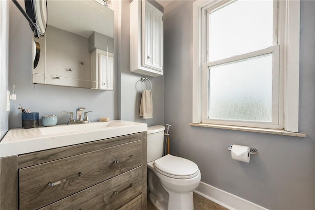 1521 Claim St, Troy Hill, PA 15212 - bathroom with plenty of natural light, toilet, vanity, and baseboards