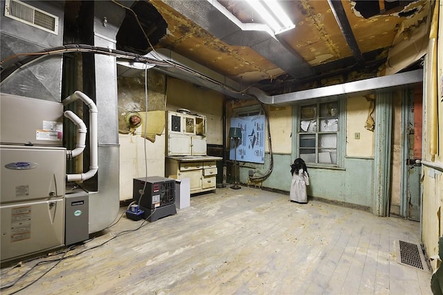 1521 Claim St, Troy Hill, PA 15212 - unfinished basement with wood-type flooring and heating unit