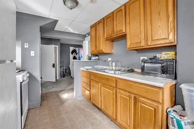 1303 Alton St, Beechview, PA 15216 - kitchen with white range, light countertops, a paneled ceiling, black microwave, and a sink