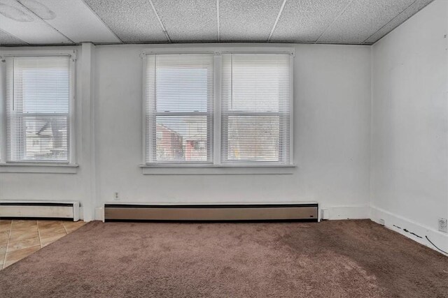 1303 Alton St, Beechview, PA 15216 - carpeted spare room with a baseboard heating unit, healthy amount of natural light, and a drop ceiling