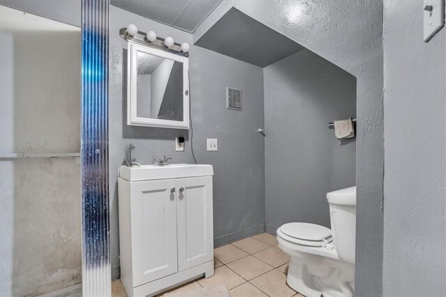 1303 Alton St, Beechview, PA 15216 - bathroom with toilet, vanity, and tile patterned floors