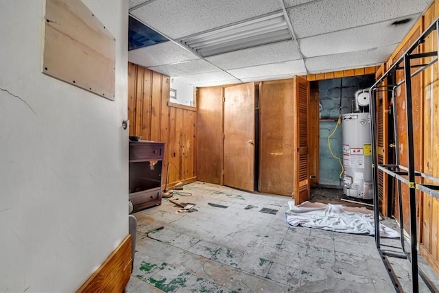 1303 Alton St, Beechview, PA 15216 - finished below grade area with gas water heater, a paneled ceiling, and wooden walls