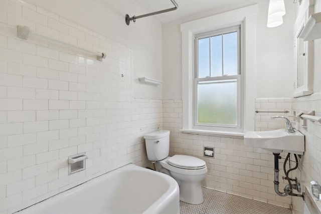 5465 Coral St, Friendship Park, PA 15206 - bathroom featuring a bathtub, tile walls, tile patterned flooring, toilet, and a wainscoted wall
