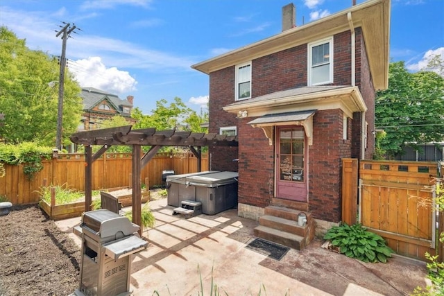 5465 Coral St, Friendship Park, PA 15206 - rear view of property featuring brick siding, a hot tub, a fenced backyard, entry steps, and a patio area