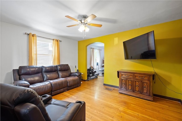 1415 Oakglen St, Crafton Heights, PA 15204 - living area with arched walkways, ceiling fan, light wood-style flooring, and baseboards