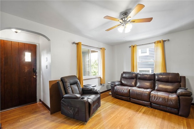 1415 Oakglen St, Crafton Heights, PA 15204 - living room with arched walkways, light wood finished floors, and a ceiling fan