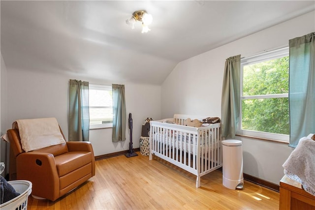 1415 Oakglen St, Crafton Heights, PA 15204 - bedroom with lofted ceiling, light wood-style floors, baseboards, and a crib