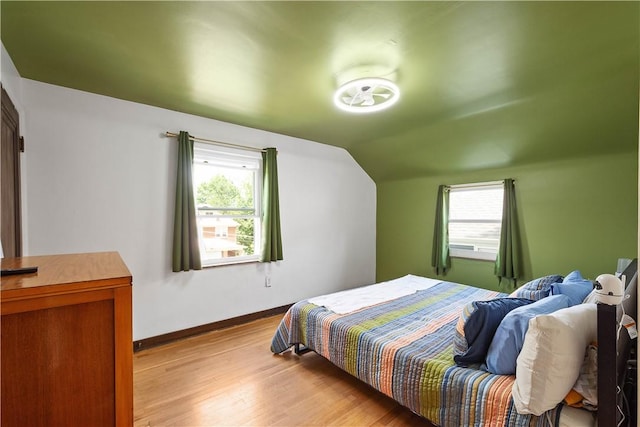 1415 Oakglen St, Crafton Heights, PA 15204 - bedroom featuring wood finished floors, multiple windows, baseboards, and vaulted ceiling