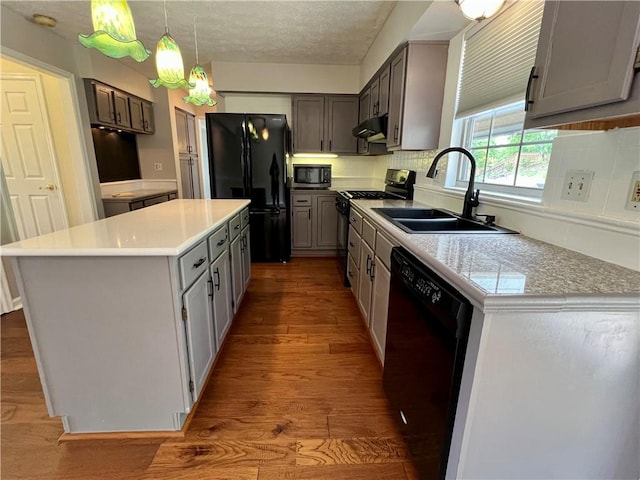 758 Venango Ave, Shaler, PA 15209 - kitchen with black appliances, a sink, wood finished floors, a center island, and tasteful backsplash