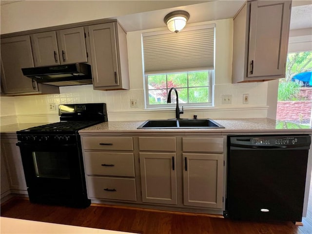 758 Venango Ave, Shaler, PA 15209 - kitchen with black appliances, under cabinet range hood, a sink, light countertops, and dark wood finished floors