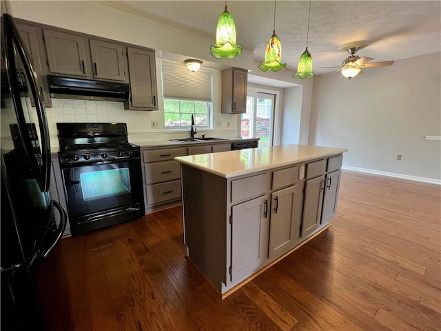 758 Venango Ave, Shaler, PA 15209 - kitchen featuring black appliances, a sink, under cabinet range hood, dark wood-type flooring, and backsplash